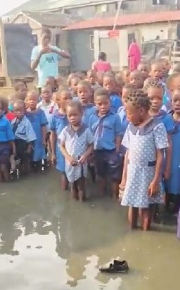 Lagos State Govt reacts to viral video of pupils singing the National Anthem in flooded school assembly ground